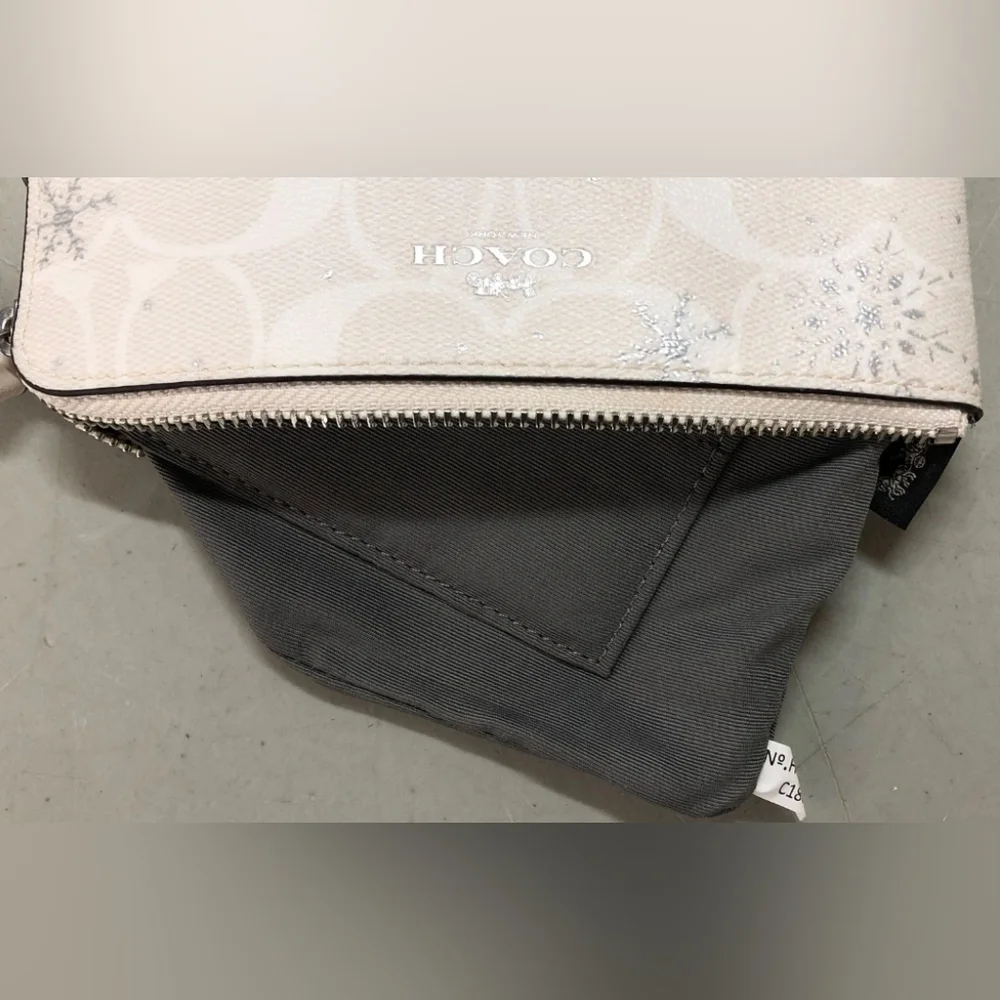 Coach Snowflakes white Wristlet.